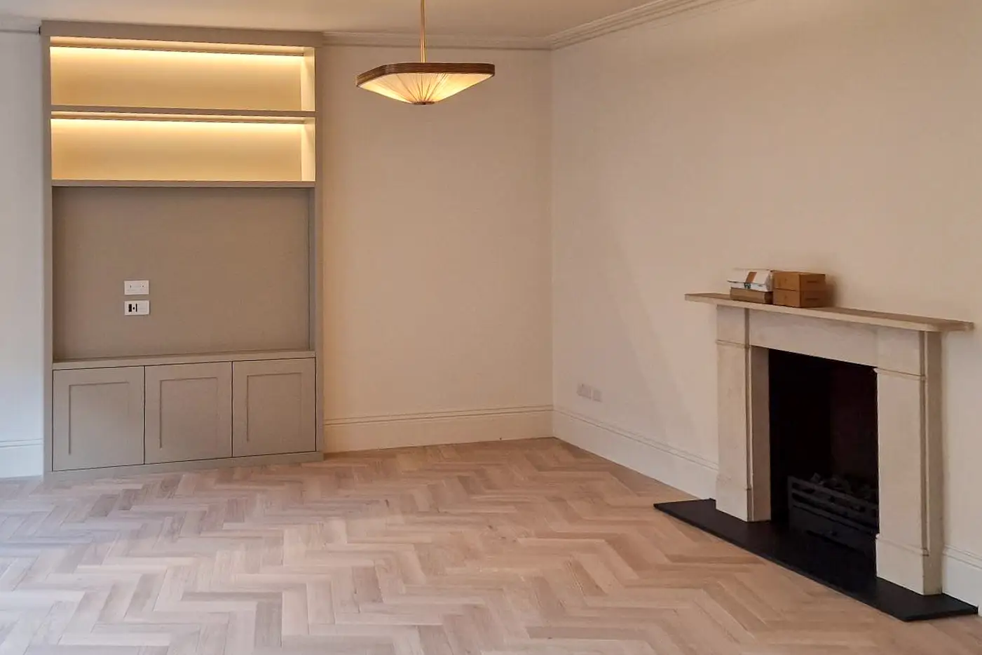 Custom built-in TV media wall with integrated LED shelving in Epsom, Surrey