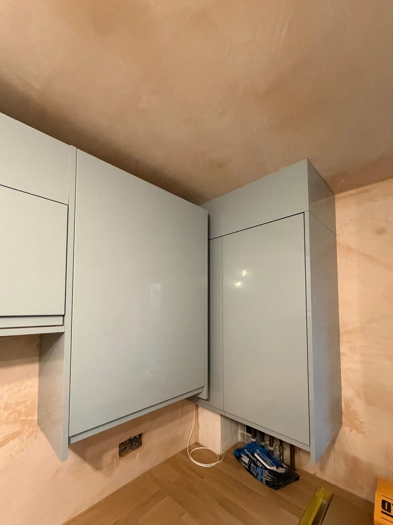 Boiler housing seamlessly integrated into bespoke fitted kitchen units in Sutton Surrey