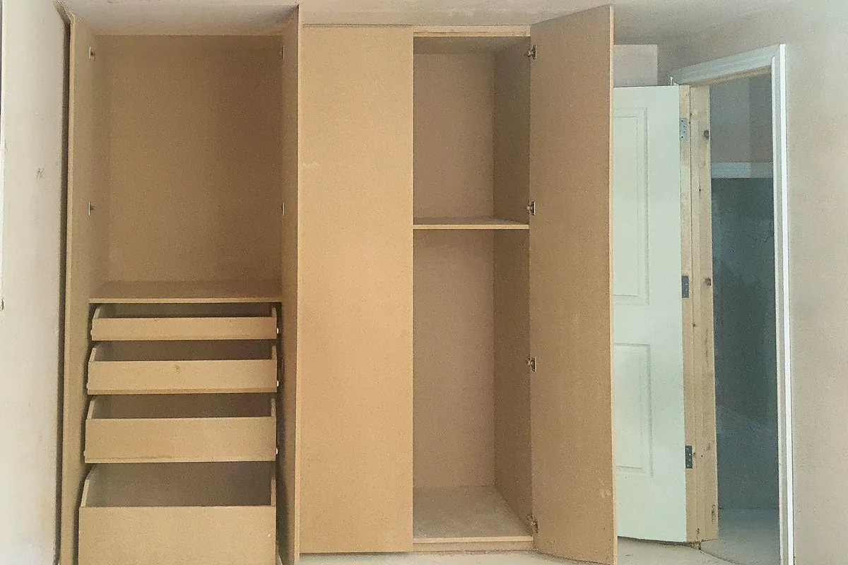 Fitted MDF wardrobe carcass built into a bedroom alcove in Beckenham