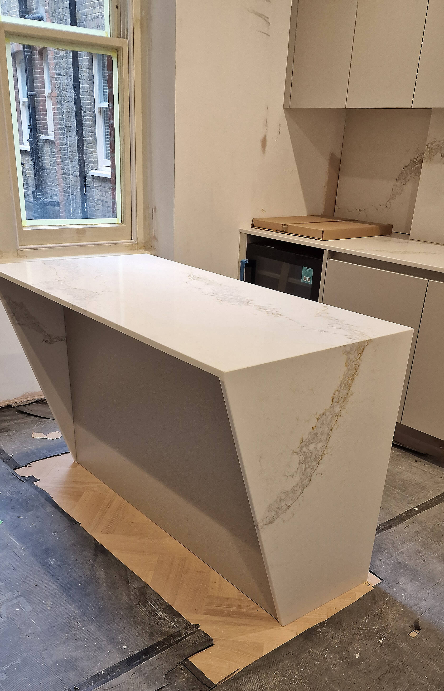 Kitchen island with quartz waterfall countertop, Chelsea SW10 Bespoke kitchen island with a quartz waterfall countertop, part of a full apartment renovation in Chelsea, SW10