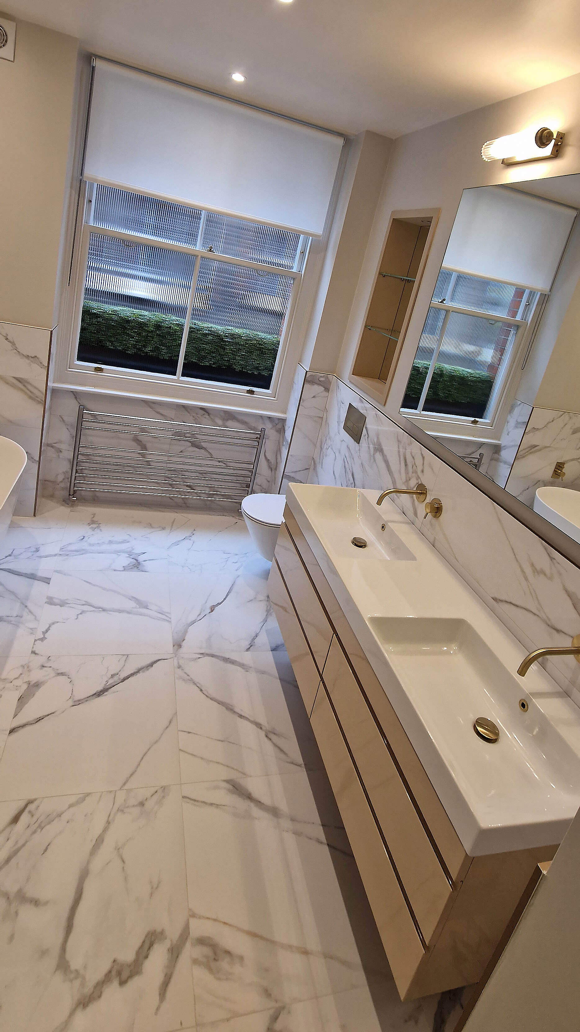 Marble bathroom vanity, part of the coordinated fit-out, Chelsea SW10 Marble bathroom vanity with a heated towel rail, Chelsea SW10