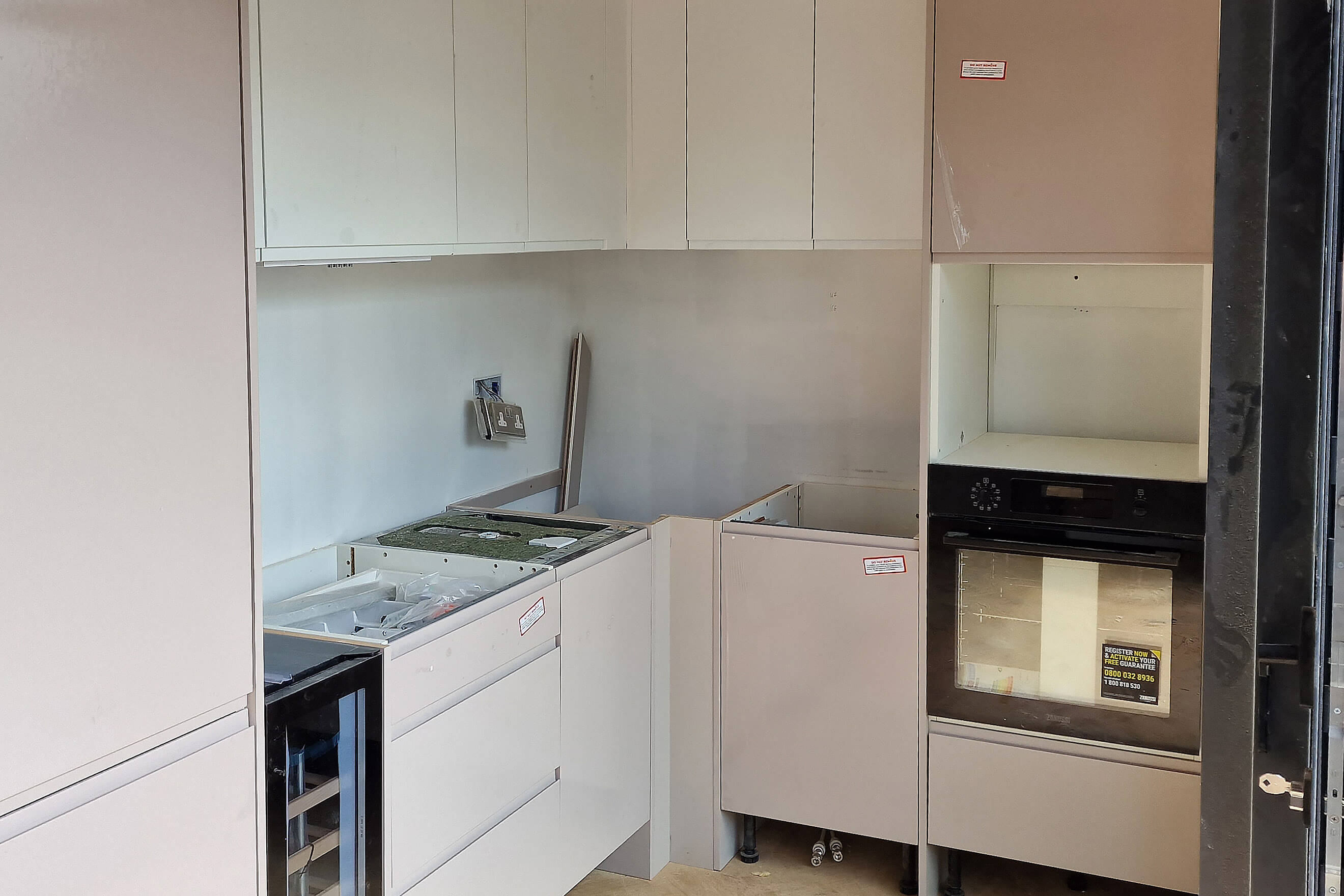Bespoke kitchen installation with integrated oven and wine cooler in Selsdon