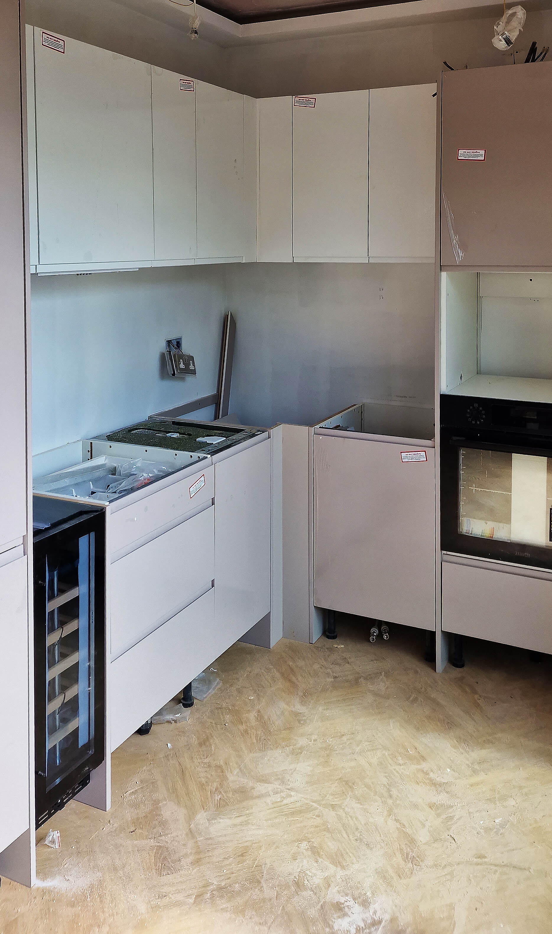 Compact fitted kitchen corner units with integrated wine cooler in Croydon