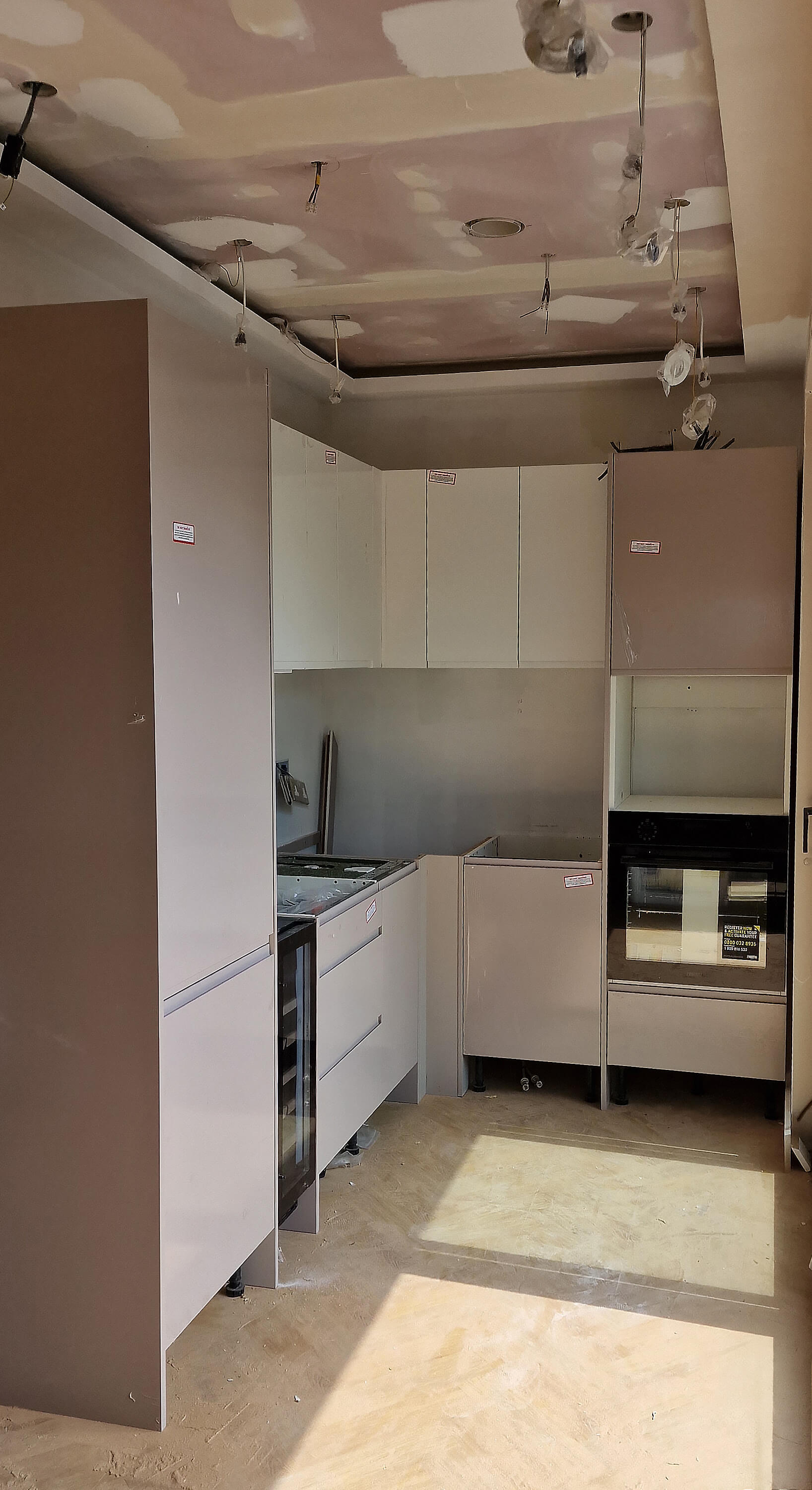 Small fitted kitchen with two-tone cabinets in Croydon, Surrey