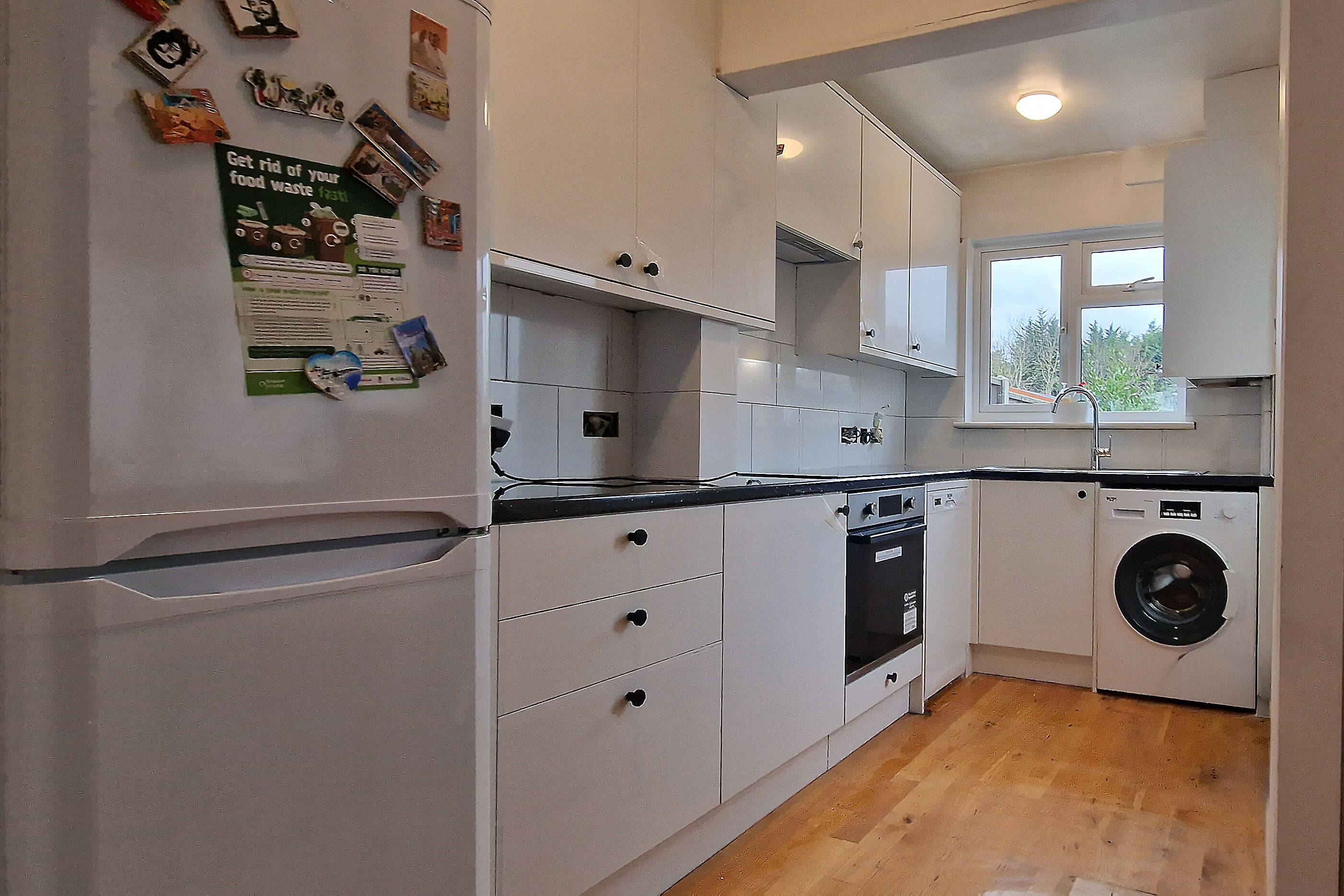 New white gloss kitchen units and dark worktop fitted in Wallington, SM6
