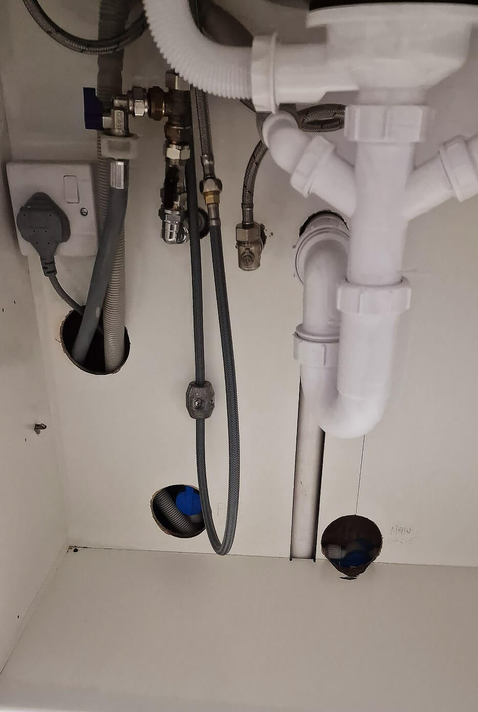 New plumbing installed under the kitchen sink during renovation in Shepherds Bush