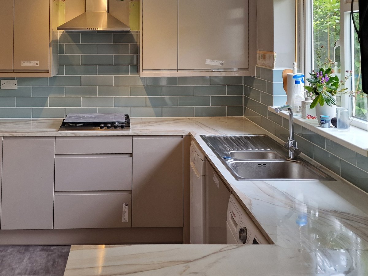 Close-up of the gas hob, sage green metro splashback and sink run in the Tooting, SW17 kitchen renovation