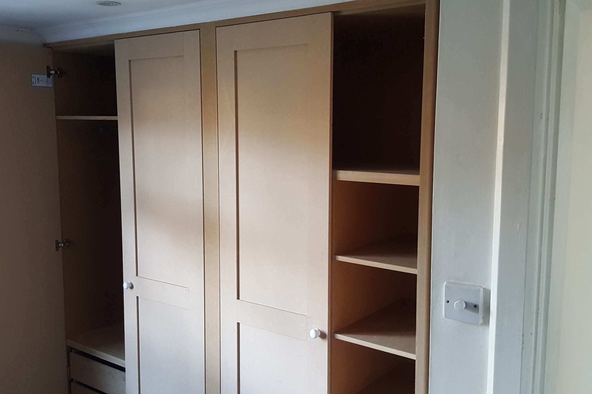Fitted wardrobe in Streatham Hill with Shaker-style doors, open shelves and drawers