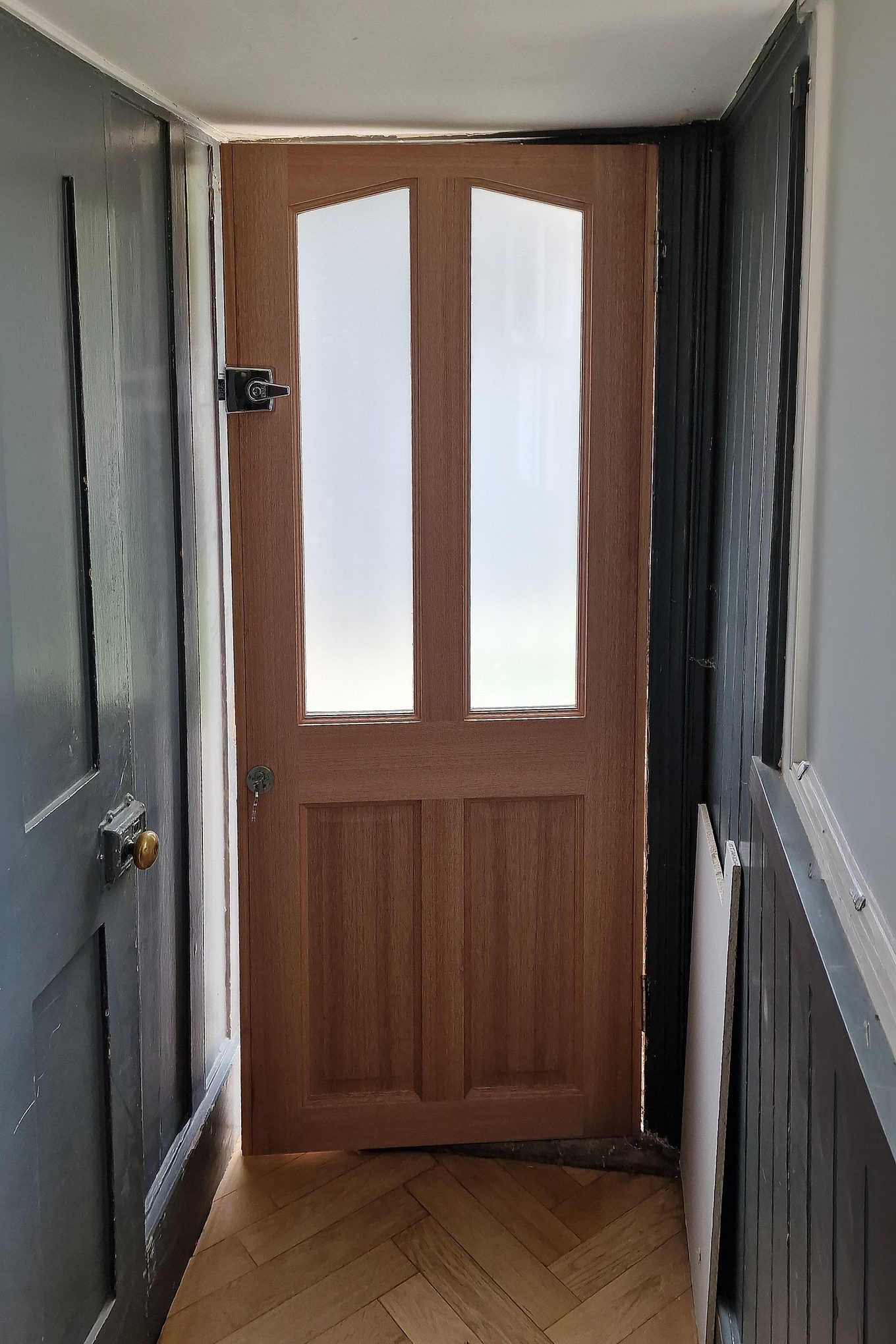 Inside view of the new timber external door in Hampton Wick with a night latch and herringbone floor