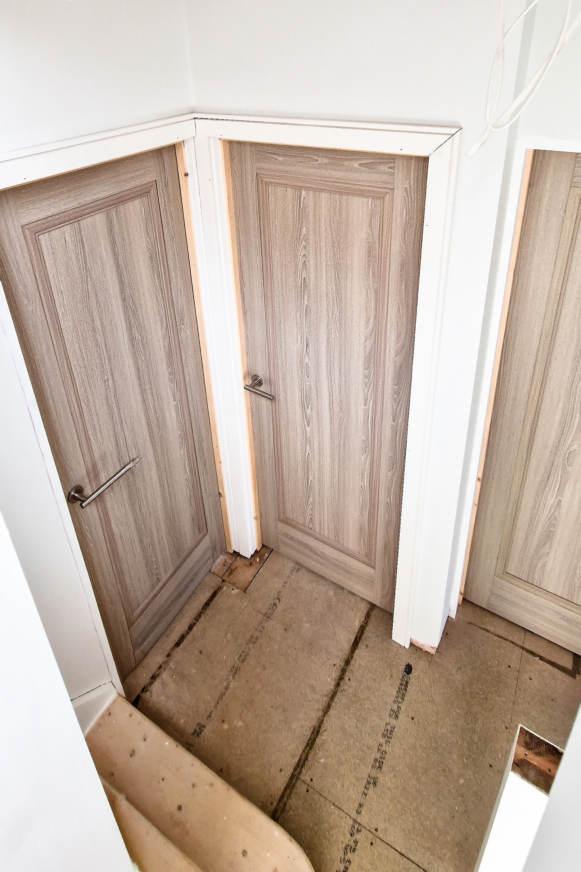 Multiple grey fire doors installed around a staircase landing in Twickenham, overhead view