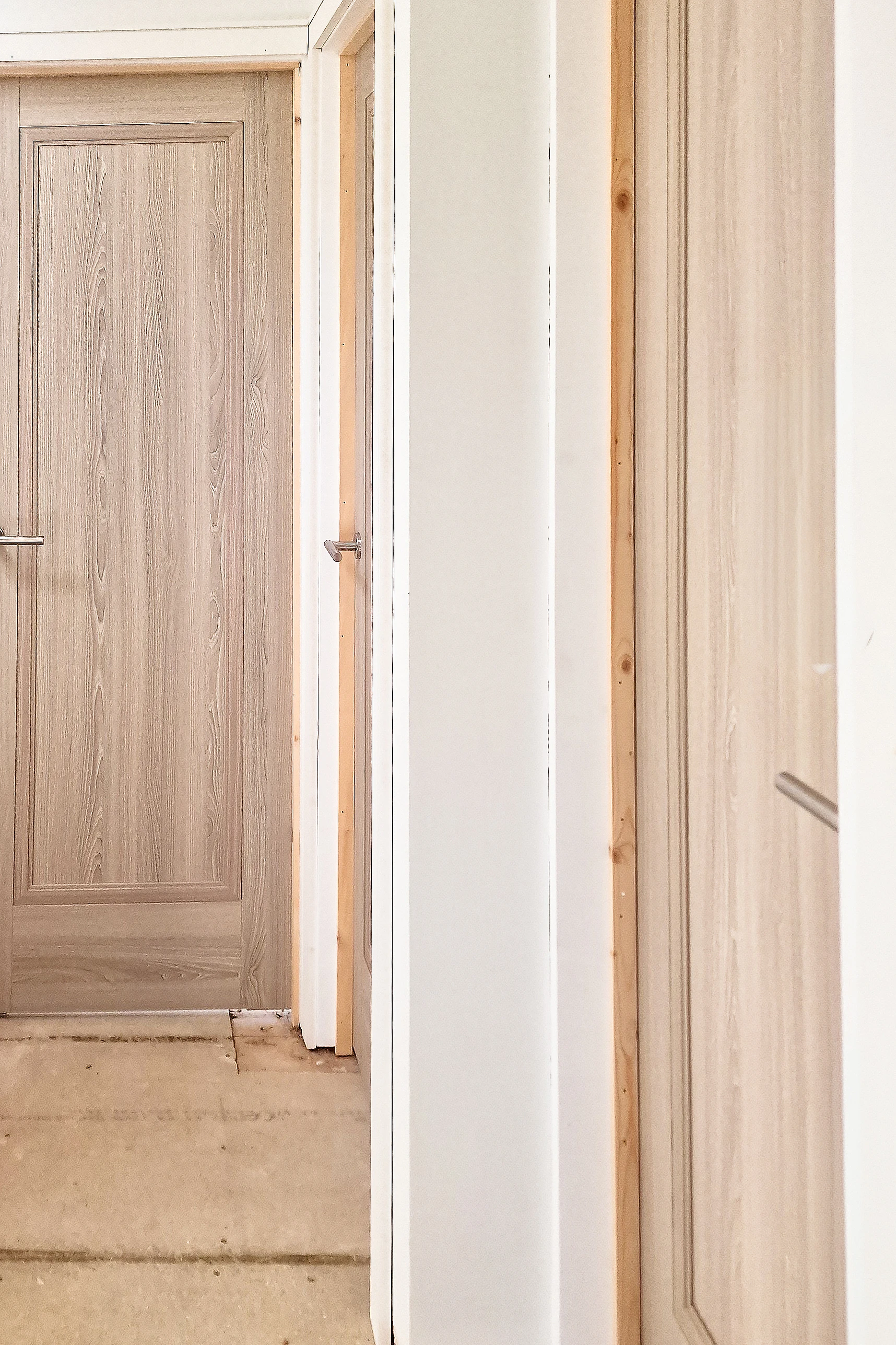 Two grey fire doors fitted in a residential hallway during renovation in Twickenham