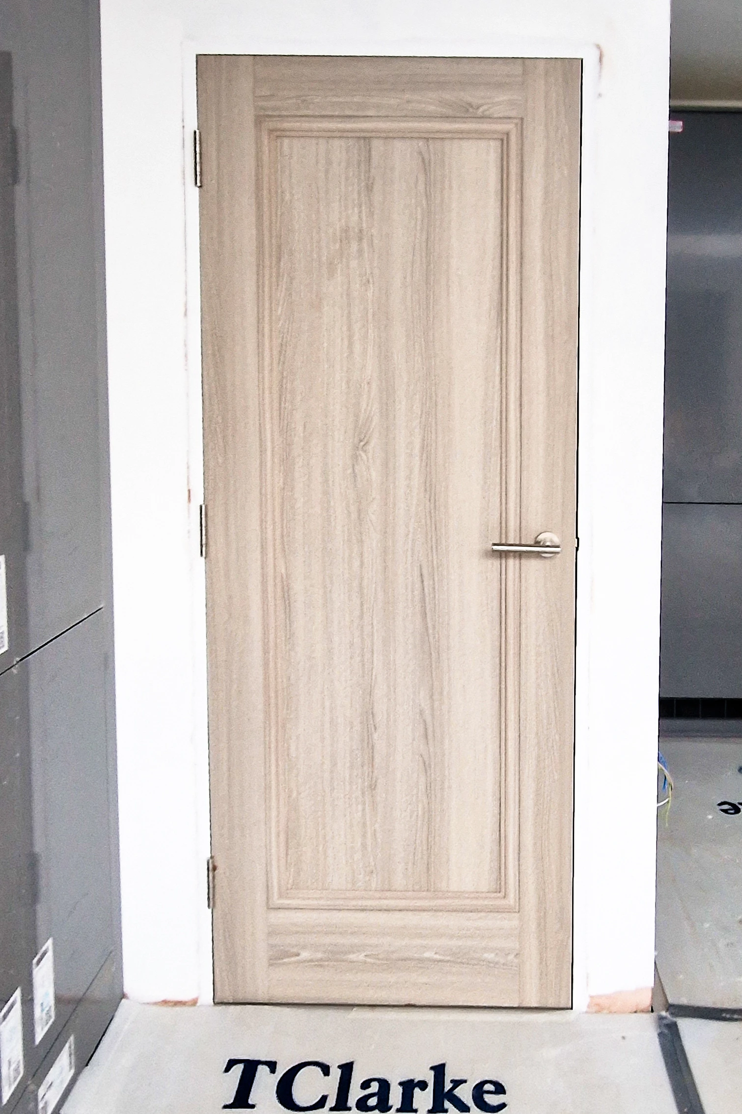 Grey panelled fire door fully hung and finished with silver lever handle, Twickenham