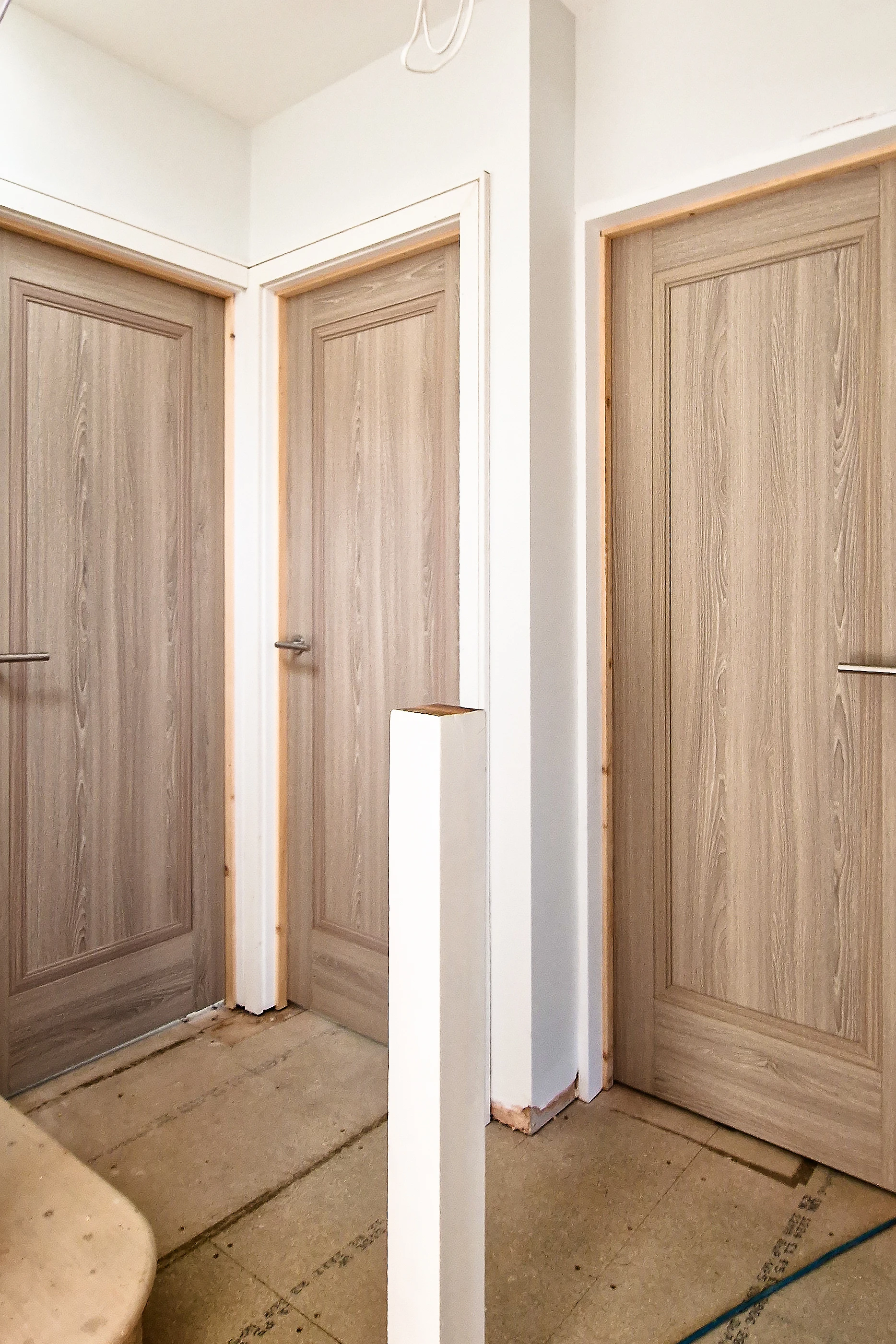 Three grey fire doors installed on a residential landing in Twickenham during renovation works