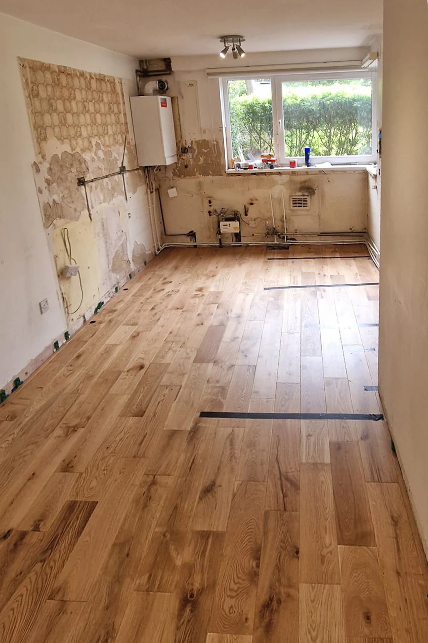 New engineered oak floor laid in Wandsworth kitchen during renovation, before kitchen units installed