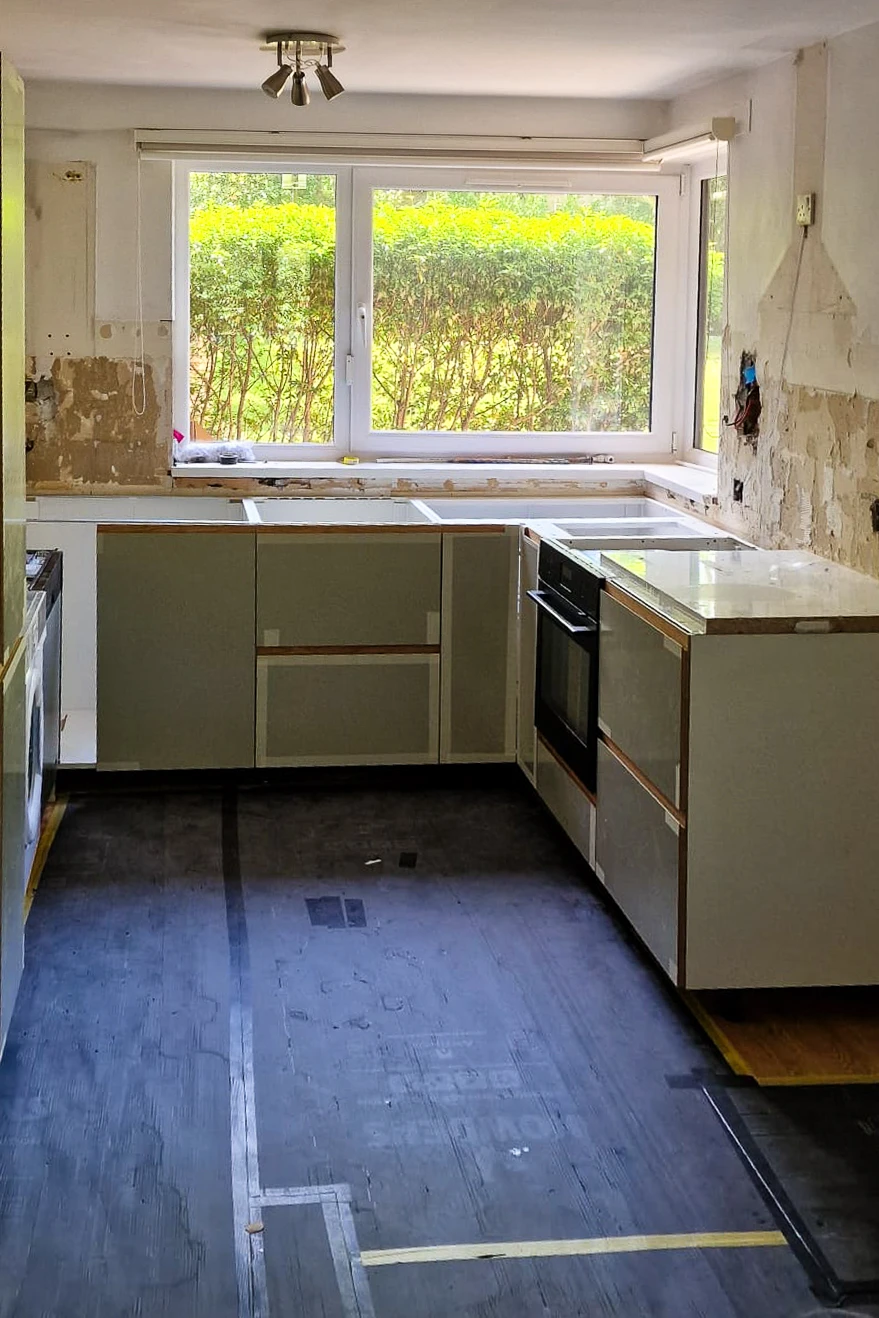 IKEA kitchen carcasses fitted with sage green Plykea fronts in Wandsworth, worktop not yet installed